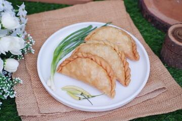 Curry puff or Pastel Goreng is Pastry Popular in Indonesia. fried pastry with filling of sauted vegetable, chicken and boiled egg. accompanied with  sauce or raw chilli pepper