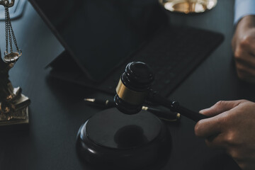 Business and lawyers discussing contract papers with brass scale on desk in office. Law, legal services, advice, justice and law concept picture with film grain effect