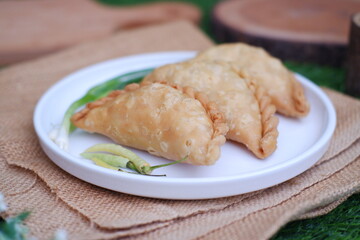 Curry puff or Pastel Goreng is Pastry Popular in Indonesia. fried pastry with filling of sauted vegetable, chicken and boiled egg. accompanied with  sauce or raw chilli pepper