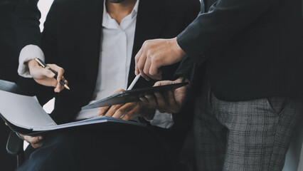 Fototapeta premium Business team working with new startup project plan and discussion information for financial strategy with laptop and digital tablet in a modern business lounge.