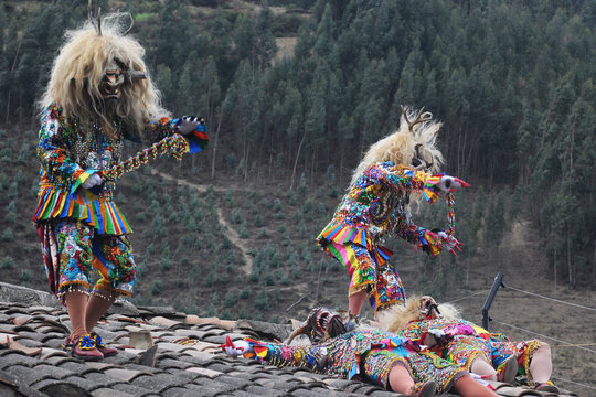 Paucartambo Peru during the procession of the Saqras mischievous devils surround it from the roofs and balconies but they cannot approach the Virgin of Carmen.