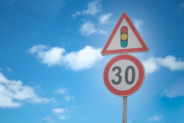 Speed Limit (30km) sign against blue sky 