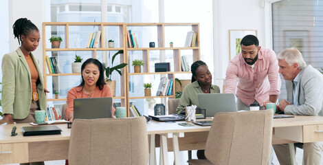 Business people, teamwork and planning on laptop, discussion and brainstorming strategy in creative startup. Computer, collaboration and group of writers on table in meeting, training and cooperation