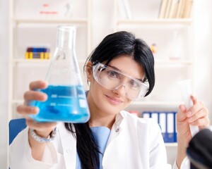 Female chemist working at the lab
