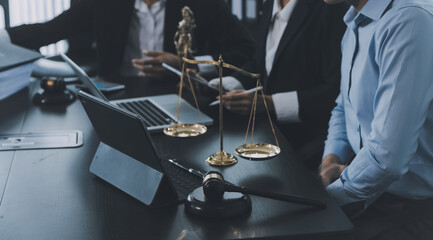 Business and lawyers discussing contract papers with brass scale on desk in office. Law, legal services, advice, justice and law concept picture with film grain effect