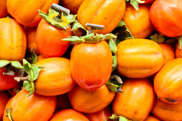 Persimmon fruits background.