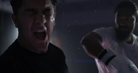 Dramatic moment of fighter getting punched in the face in super slow-motion at 800 fps with sweat droplets flying in the air. Boxing impact scene