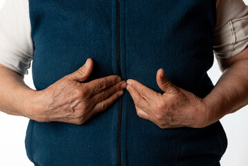 old woman with stomach pain. An old woman holding her stomach because of severe pain. indigestion...