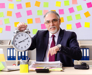 Aged man employee in conflicting priorities concept