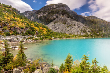Fototapeta na wymiar Autumn colors at Joffre Lakes Provincial Park in British Columbia. A colorful scene with the turquoise water of the upper Joffre Lake and Autumn colors. 