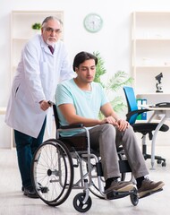 Male patient in wheel-chair visiting old doctor