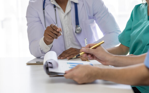 Medical, meeting and healthcare workers  for team in office, discussion, brainstorming and planning. Doctor, nurse and computer on desk show diversity in collaboration or workshop for data analytics