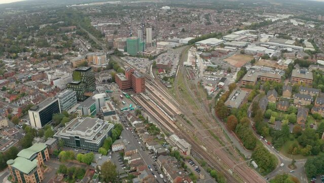 Wide circling aerial shot of Watford Junction train station