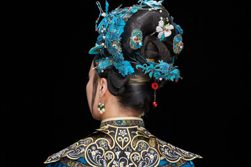 A Asian woman dressed in Qing Dynasty Empress attire