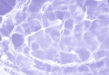 Natural background of water in summer. Blue surface. Clear water with ripples and splashes. water waves in sunlight The water surface has waves.