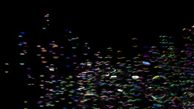 Vertical of soap water bubbles texture flying over black abstract background