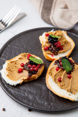 canapes with pate, mint leaves and berries, side view