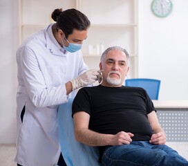 Old man visiting young doctor for plastic surgery