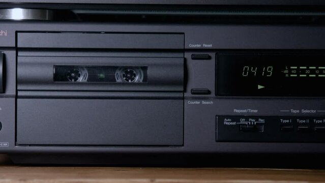 Footage of a vintage tape deck or cassette player with a tape counter.