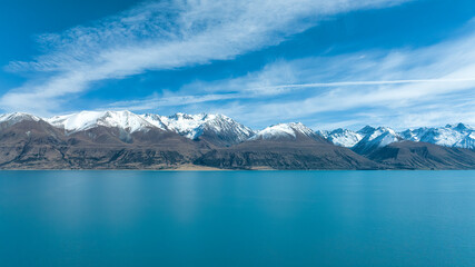 Drone  photograph of the shore of Lake pukaki  and the Snow capped Southern Alps peaks in the background