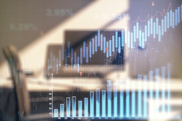 Double exposure of abstract creative financial diagram and modern desk with computer on background, banking and accounting concept