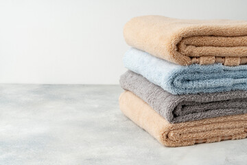 Fototapeta na wymiar Stacked clean fluffy towels in a bathroom