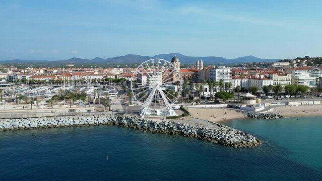 Drone shot of the Ferris Wheel of Saint-Raphael and coastal old port district in Cote d'Azur, France