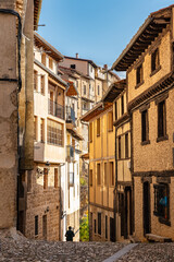 Fototapeta na wymiar Alley with old houses and cobblestones on the ground in the picturesque village of Frias, Burgos, Spain.