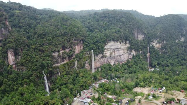Forest in the mountains with waterfalls falling between valleys, in West Sumatra, Indonesia