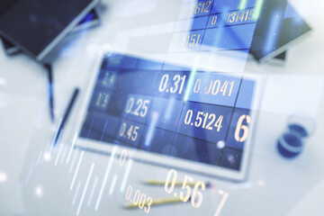 Multi exposure of abstract creative financial graph and modern digital tablet on background, top view, forex and investment concept