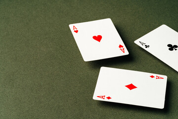 Playing cards on green background studio shot