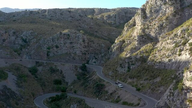 Cars travelling on narrow winding road in Serra de Tramuntana mountain range on the Mallorca Island in Spain.