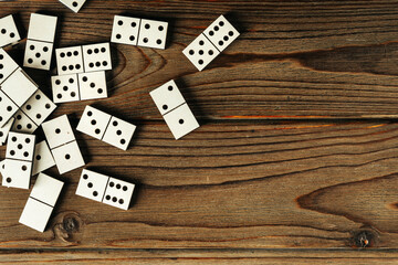 Domino tiles on wooden background close up