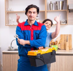 Young male repairman repairing tap