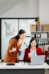 Young Asian business team creative businesspeople coworker, teamwork celebrating achievement and in planning design in creative in office.