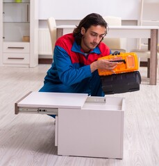 Young male carpenter working indoors