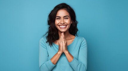 Hispanic woman standing in front of a blue background, showing a cheerful and caring smile. Romantic concept. - obrazy, fototapety, plakaty