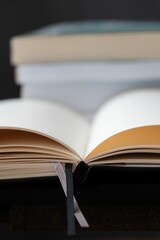 a closeup of Open blank book with books in the background