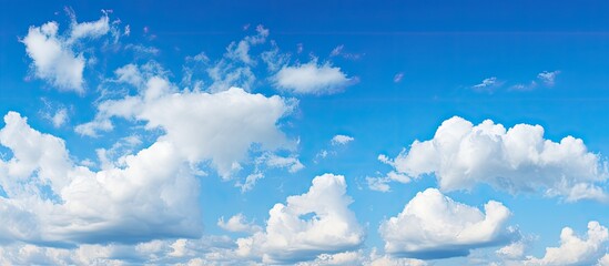 Naklejka na ściany i meble Gorgeous blue sky and white clouds as a backdrop