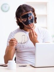 Young male cosmetician recording video for his blog