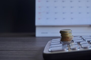 Closeup image of coins, calendar and calculator with copy space. Financial, savings and economy...