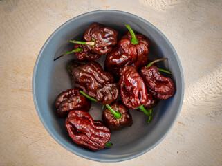 Brown hot Pot Congo Chili fruits on plate in close up view