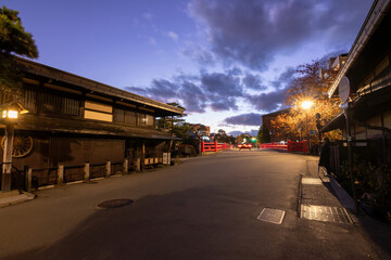 Fototapeta premium Takayama's historic old town at twilight on night sky. Traditional architecture wooden houses with light up at dusk. Beautiful town in Takayama, Gifu Prefecture, Japan.