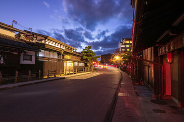 Takayama's historic old town at twilight on night sky. Traditional architecture wooden houses with light up at dusk. Beautiful town in Takayama, Gifu Prefecture, Japan.