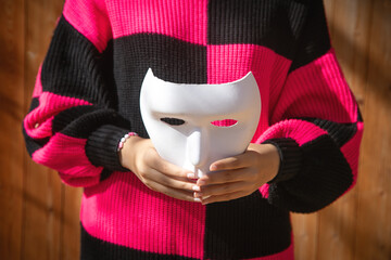 Caucasian young woman showing white face mask.