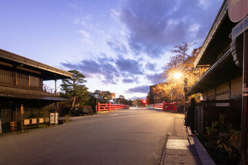 Takayama's historic old town at twilight on night sky. Traditional architecture wooden houses with light up at dusk. Beautiful town in Takayama, Gifu Prefecture, Japan.