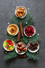 Christmas tree made of dried fruit and nuts on dark background, christmas food concept