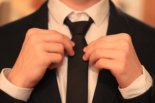 businessman adjusting his tie