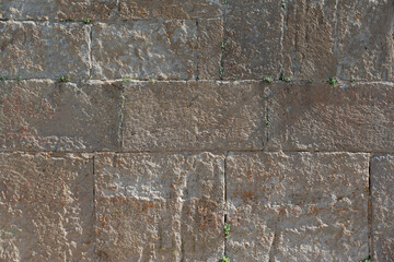 Background old wall made of porous stones of the mountainous area. Wall of an ancient church.