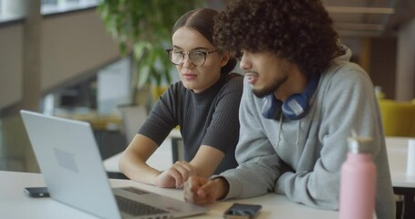 African American man and his colleague work harmoniously in an office, exemplifying the spirit of teamwork, diversity, and professional collaboration in a modern workplace